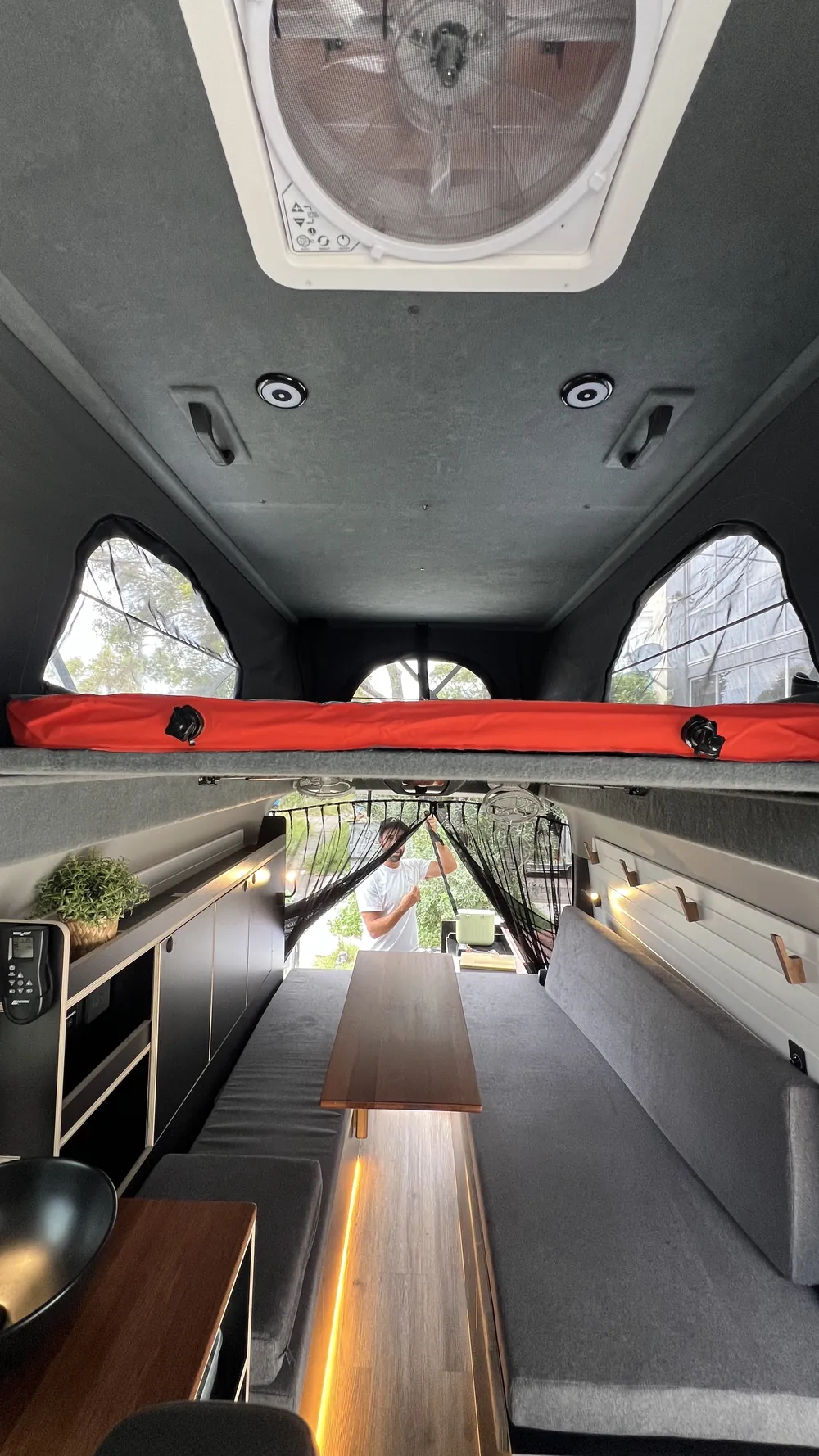 Inside a Toyota Hiace with the pop-top roof raised